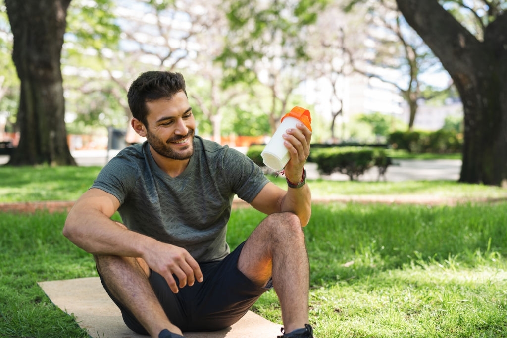 young man having natural pre-workout supplement drink
